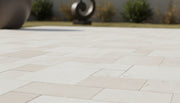 Close-up of Desert Sand Limestone Tumbled Roman x 1.25 Paver, in Desert Sand tones.