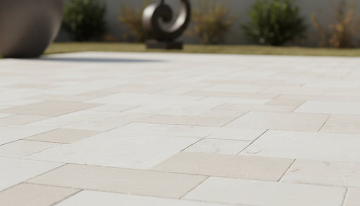 Close-up of Desert Sand Limestone Tumbled Roman x 1.25 Paver, in Desert Sand tones.