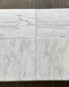 Close-up of Natural Carrara Equinox Marble Leather (Sandblasted & Brushed) 16 x 24 x 1.25 Paver, in Natural tones.