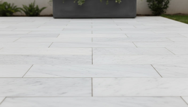 Close-up of Natural Carrara Equinox Marble Leather (Sandblasted & Brushed) 16 x 24 x 1.25 Paver, in Natural tones.