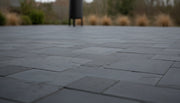 Close-up of Indian Black Limestone Tumbled French Versailles x 1.25 Paver, in Black tones.