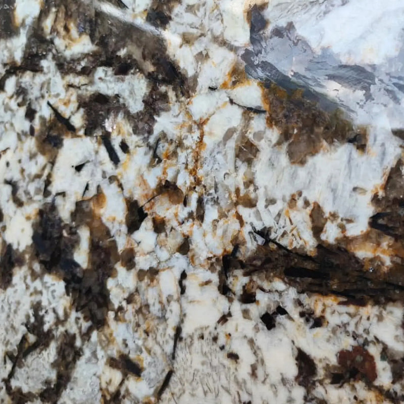 Panda Oro 3cm polished granite slab with white crystalline areas, dark brown and black mineral patches and golden accents.
