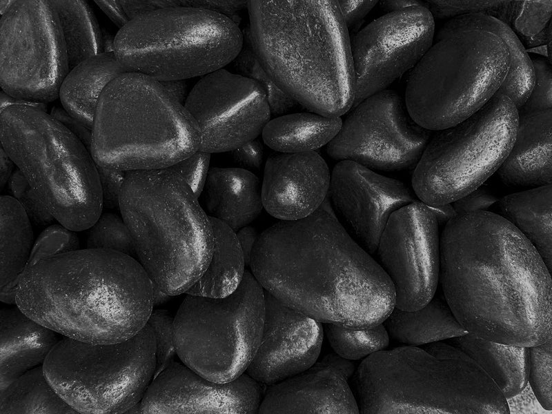 Close-up of Black Stone Polished 2 - 5CM (3/4 - 2 Inch) Medium Black Ultra Pebbles, in Black tones.