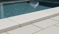 Close-up of Antalya Cream Marble Leather (Sandblasted & Brushed) 12 x 24 x 2 Modern Coping, in Cream tones.