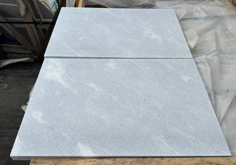 Close-up of Blue Island Marble Leather (Sandblasted & Brushed) 16 x 24 x 2 Double Modern Coping, in Blue Island tones.