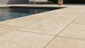 Close-up of Ivory Cordoba Cream Travertine Tumbled 12 x 24 x 2 Modern Coping, in Ivory tones.