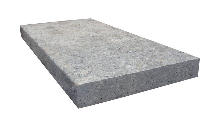 Close-up of Silver Travertine Tumbled 12 x 24 x 2 Modern Coping, in Silver tones.