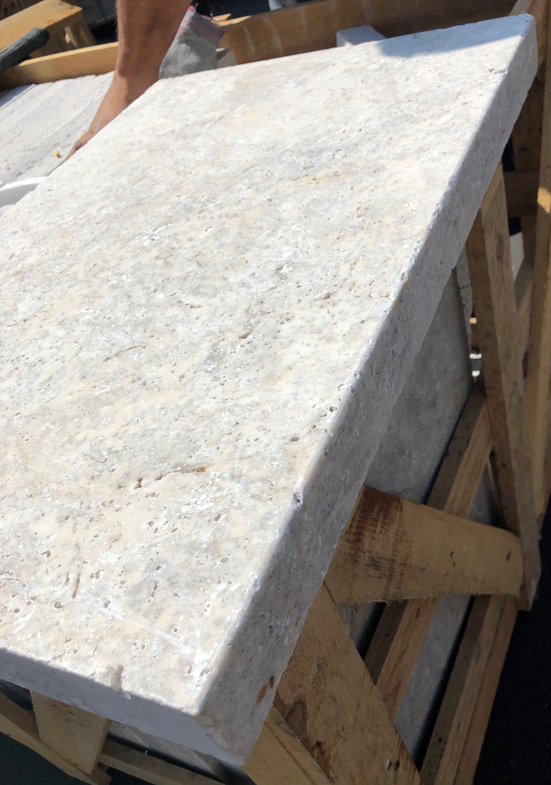 Close-up of Silver Travertine Tumbled 16 x 24 x 2 Modern Coping, in Silver tones.