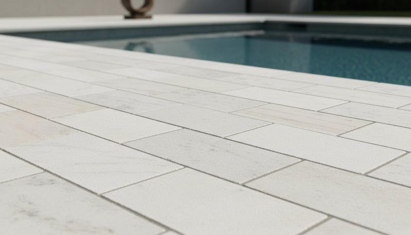 Close-up of Natural Carrara Equinox Marble Leather (Sandblasted & Brushed) 16 x 24 x 2 Modern Coping, in Natural tones.