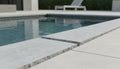 Close-up of Natural Indian Bluestone Limestone Tumbled & Brushed 12 x 24 x 2 Modern Coping, in Natural tones.