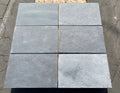 Close-up of Indian Black Limestone Tumbled & Brushed 16 x 24 x 2 Modern Coping, in Black tones.