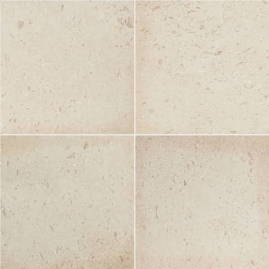 Four Pearl 16x16 tumbled limestone pavers in a light cream shade with subtle natural markings.