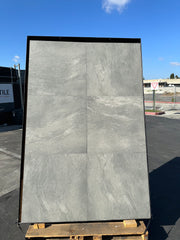 Close-up of Pluto Grey Porcelain Rough & Straight Edge 24 x 48 x 3/4 Paver, in Grey tones.