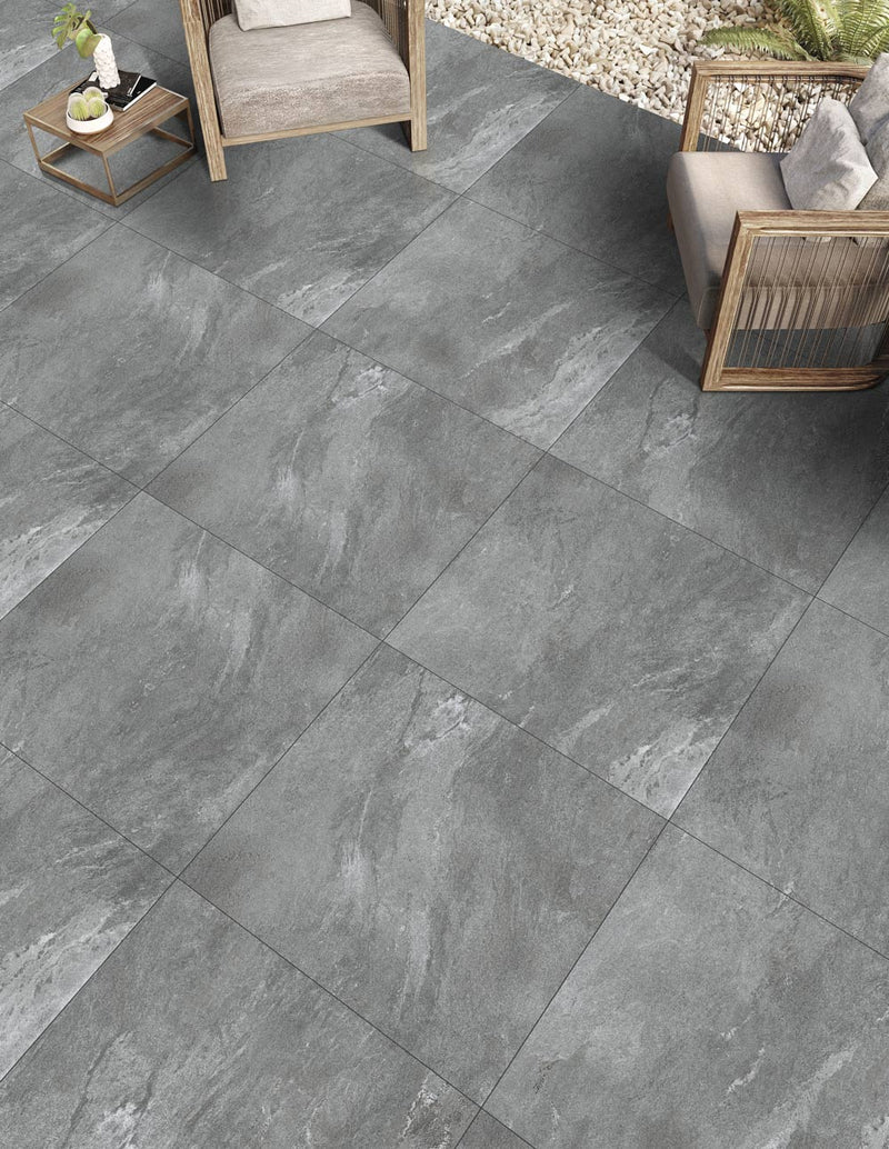 Close-up of Pluto Grey Porcelain Rough & Straight Edge 24 x 48 x 3/4 Paver, in Grey tones.