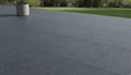 Close-up of Bluestone Dark Grey Porcelain Rough & Straight Edge 24 x 24 x 3/4 Paver, in Grey tones.