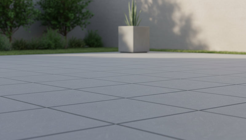 Close-up of Bluestone Light Grey Porcelain Rough & Straight Edge 24 x 24 x 3/4 Paver, in Grey tones.