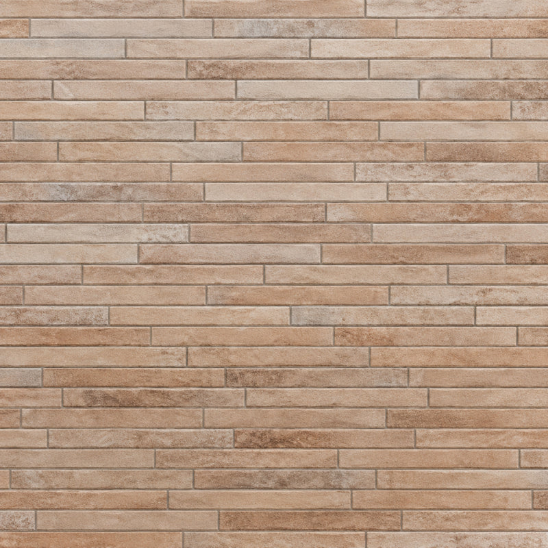 Rondine Nolita Sand 2x18 porcelain tile in sand beige with narrow rectangular tiles in a staggered layout.