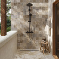Sinai Beige porcelain shower wall tiles with matte black fixtures and warm natural lighting.