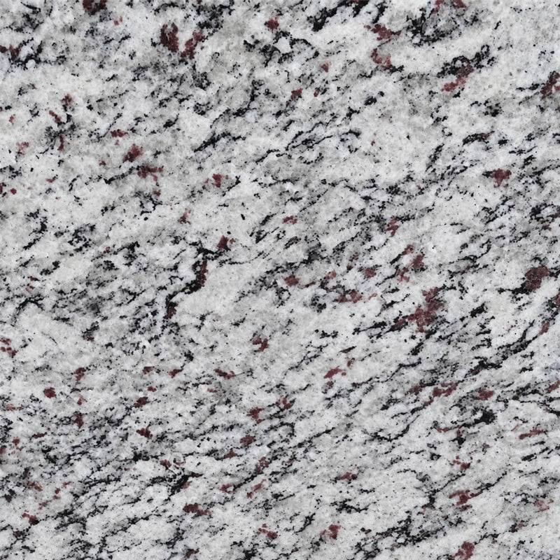 Close-up of SLAB3GRA Blanco Tulum polished granite with a light base, dark markings, and reddish mineral flecks.