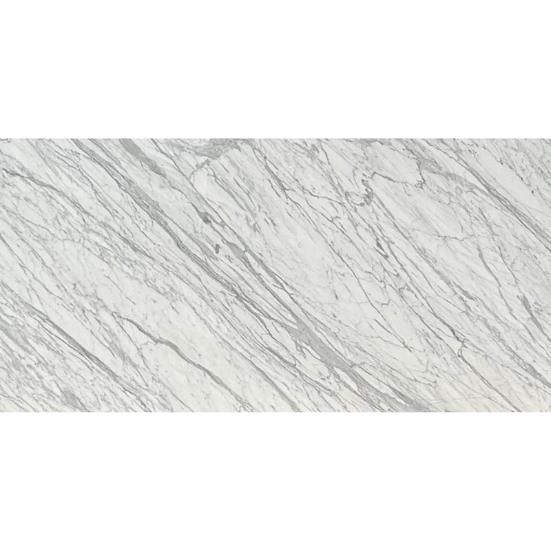 Calacatta Belgia polished marble surface with a white background and numerous fine grey veins flowing diagonally through the natural stone.