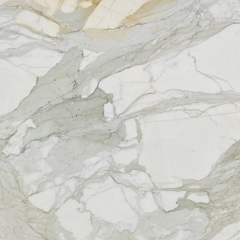 Calacatta Borghini Gold marble slab with an ivory background and flowing gray and golden-beige veins.