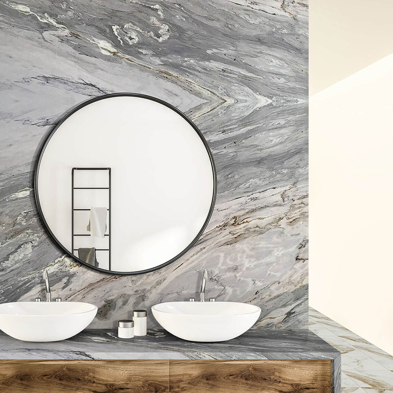 SLABMRE Portinari 3cm polished marble on a bathroom wall and vanity with gray, white and gold veins, a round mirror and two vessel sinks.