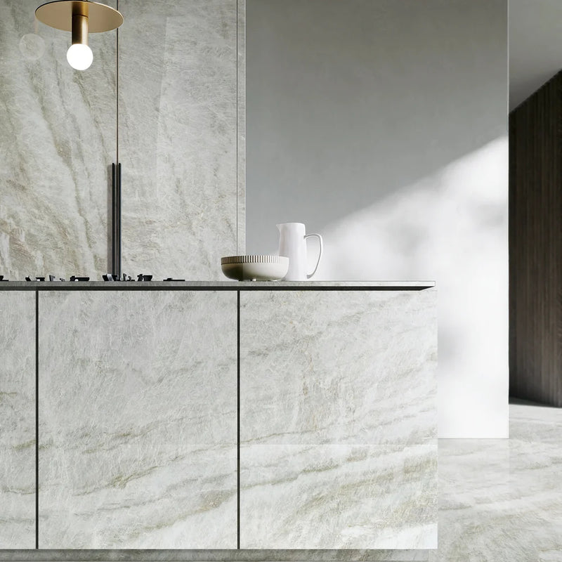 Montebello honed quartzite on a kitchen island and cabinetry with soft ivory and gray veining.