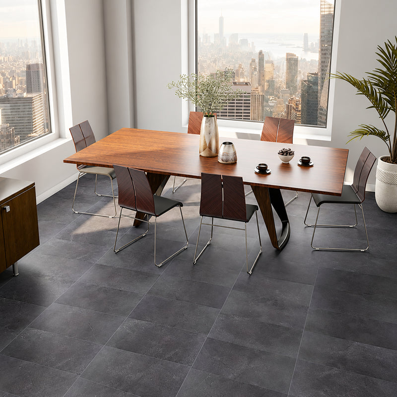 St. Croix Flint 12x24 porcelain floor tiles in a dining room with a wooden table and large windows.