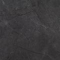 Close-up of St. Croix Flint 12x24 porcelain tile showing its charcoal-gray surface and subtle stone-look veining.