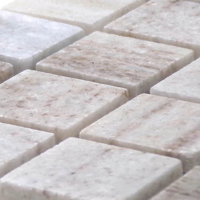 Angled close-up of STO-RE Ocean White polished marble mosaic tiles