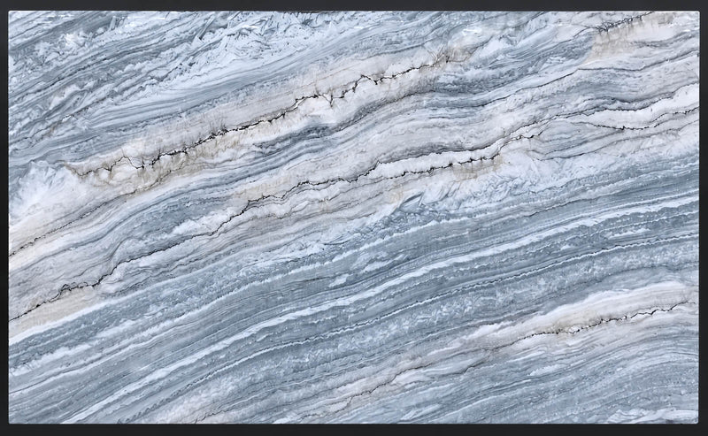 Stratus Blue polished quartzite slab with sweeping blue-gray and white layered veining.