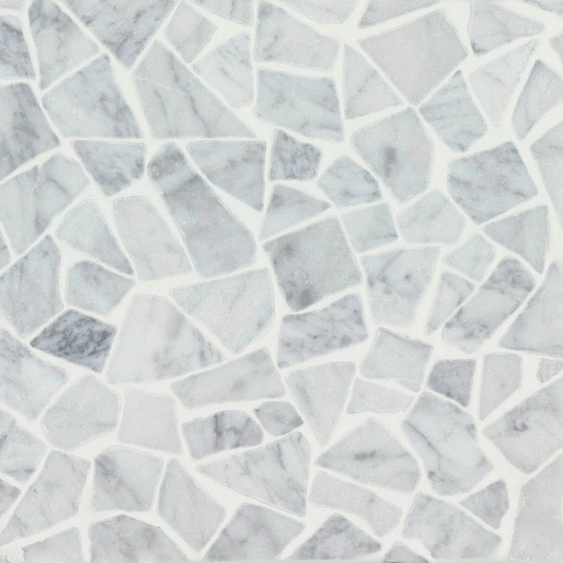 Suave Tumbled White Carrara 12x12 Pezzi marble mosaic with irregular white and gray marble pieces.