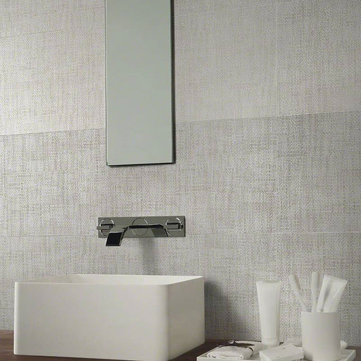 TekTile Crosshatch Gray 12x24 matte porcelain tiles on a bathroom wall behind a white vessel sink, mirror and chrome faucet.