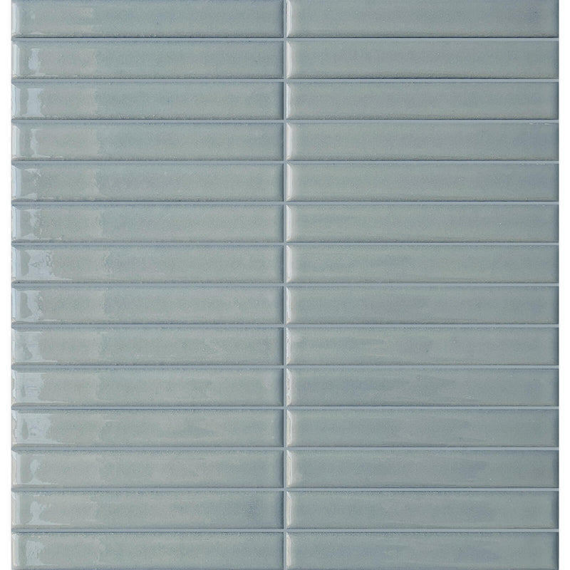 Terratinta Stick Blue Lagoon glossy mosaic with slim blue rectangular pieces in a straight stacked layout.