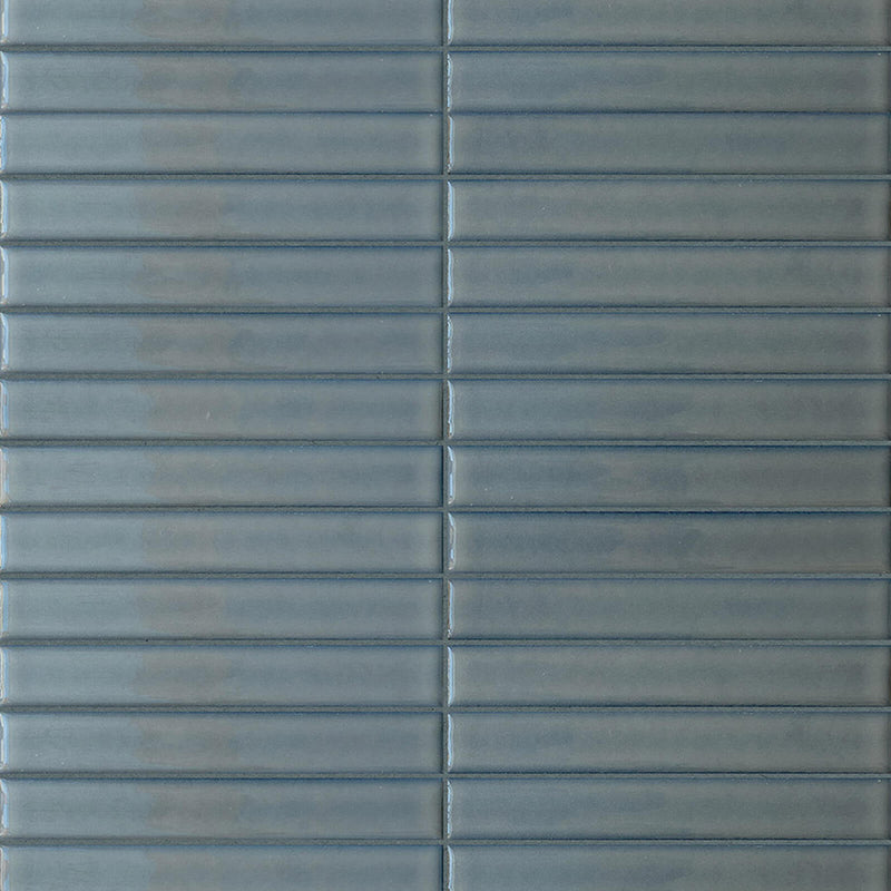 Terratinta Sticks Fjord Blue 1x6 glossy ceramic mosaic with slender blue-gray pieces and visible joints.