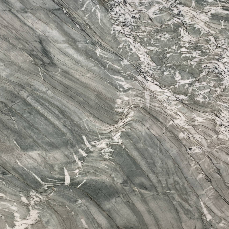 Tiffany Nassau polished quartzite slab with green-gray tones, sweeping white veins and fine dark diagonal lines.