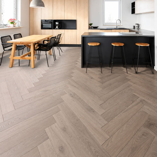 Timbertop Mauritius 4x33 European oak engineered hardwood flooring in a grey-beige herringbone pattern in a modern kitchen.
