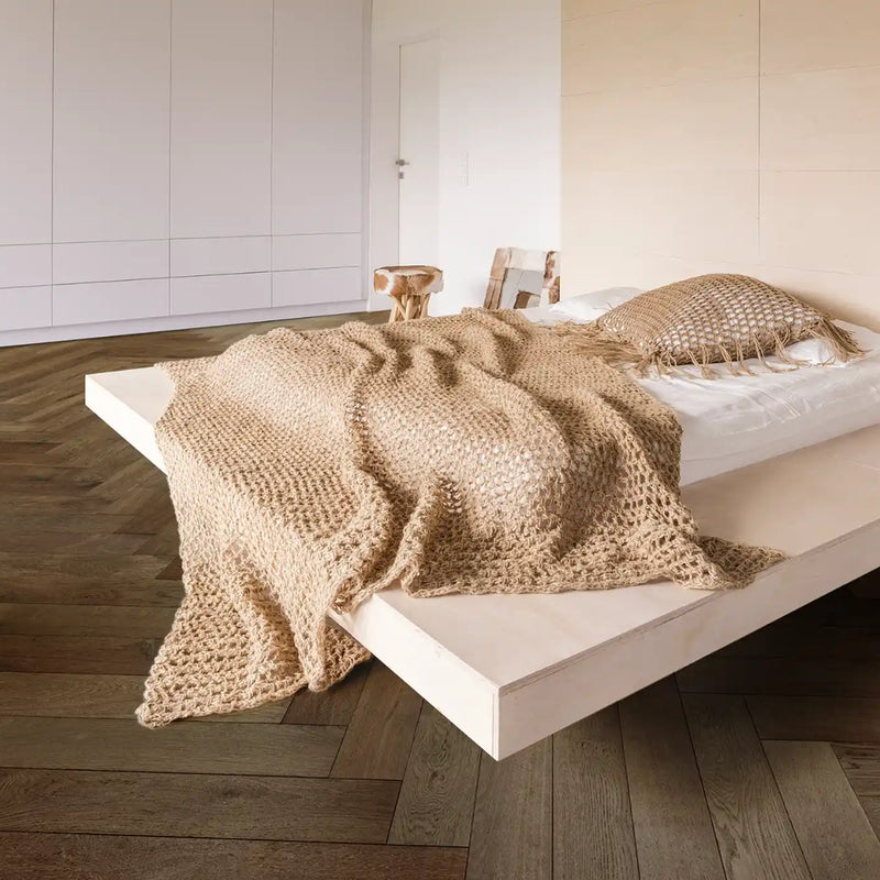 Timbertop Treviso engineered European oak herringbone flooring in a bedroom with a white platform bed and neutral bedding.