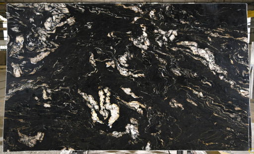 Titanium Gold 3cm leathered granite slab with a black background and flowing white, cream, and gold veining.