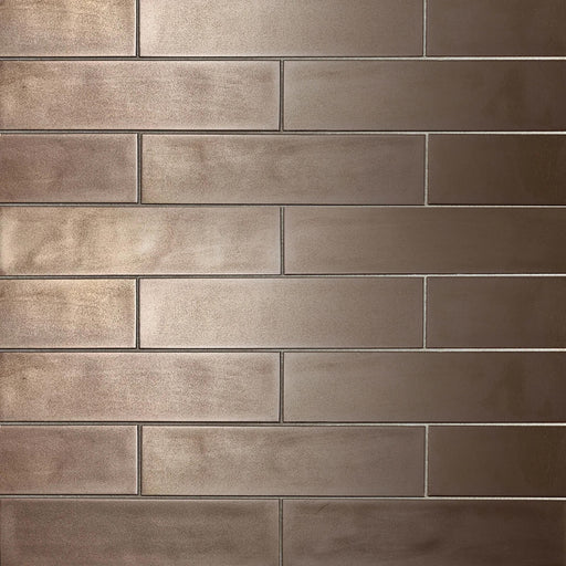 Bronze ceramic wall tile in a staggered brick layout, 10.5 × 2.5 inches.