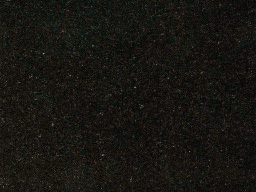 Close-up of dark Ubatuba granite with subtle green, gold, and gray mineral flecks.
