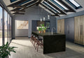 Ubatuba granite kitchen island in a modern kitchen with wood cabinetry and skylights.