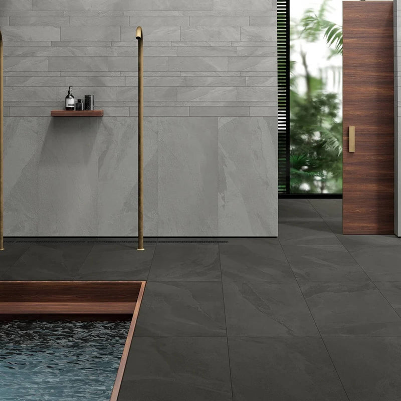 Rail Black matte porcelain tiles on the floor of a modern bathroom with gray tiled walls.