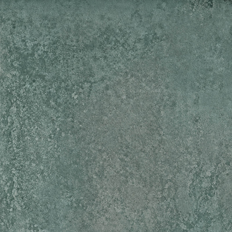 Close-up of Unicom Oxid Emerald matte porcelain with a mottled, muted green texture.