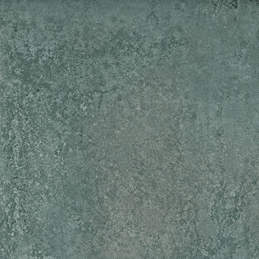 Close-up of Unicom Oxid Emerald matte porcelain with a mottled, muted green texture.