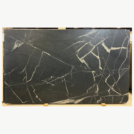 Full Vincent Black stone slab with a dark charcoal surface and branching cream and pale gold veins.