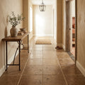 Walnut Travertine 16x16 Unfilled, Brushed & Chiseled Travertine Tile — Hallway floor