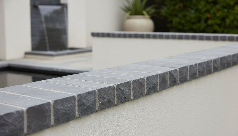 Close-up of Indian Black Limestone Natural 12 x 2 x 2 Limestone Wainscot Sill Cap, in Indian Black tones.