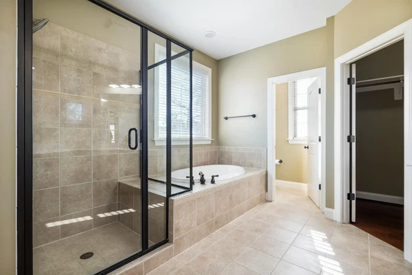 large bathrooms with same floor and shower tiles