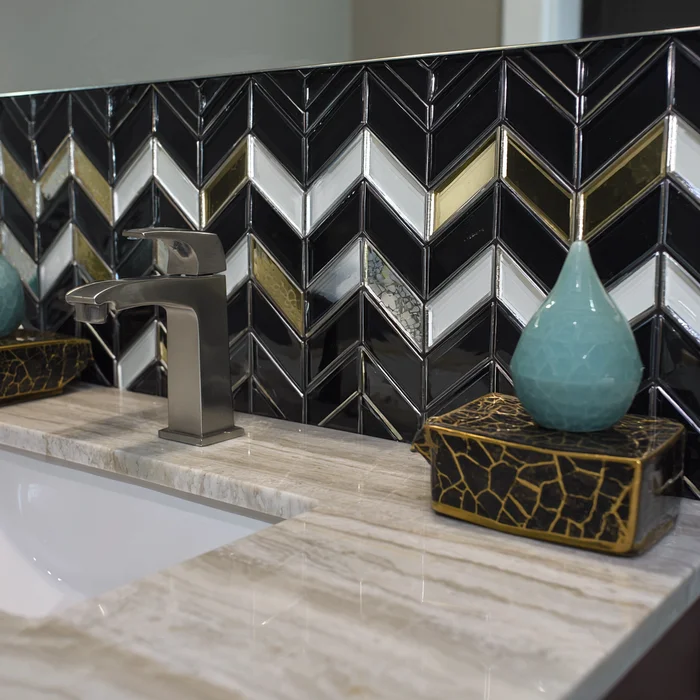 Chevron back accents with bold marble on a classic sink with chrome handle.